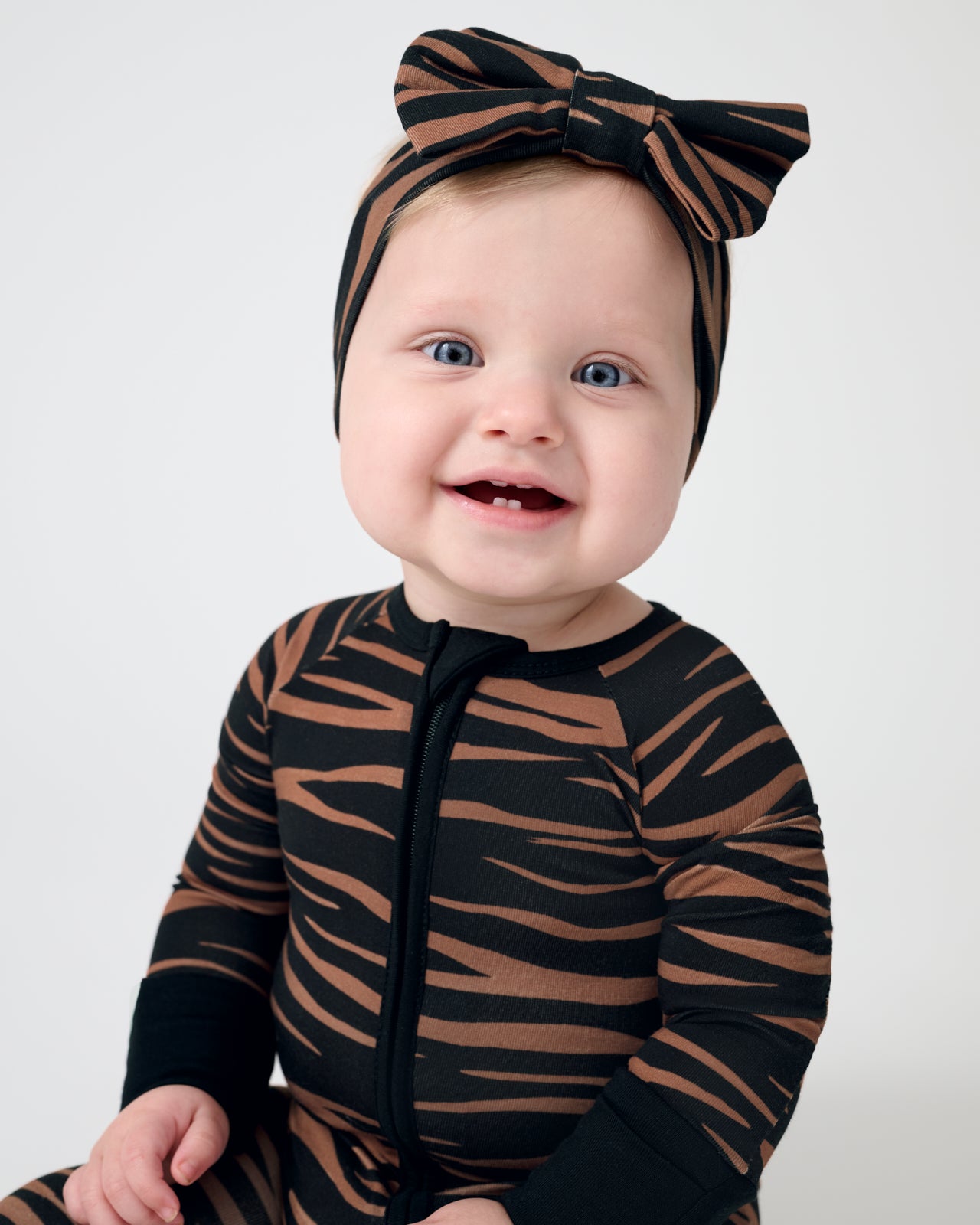 Close up of baby wearing the Wild Stripes Luxe Bow Headband