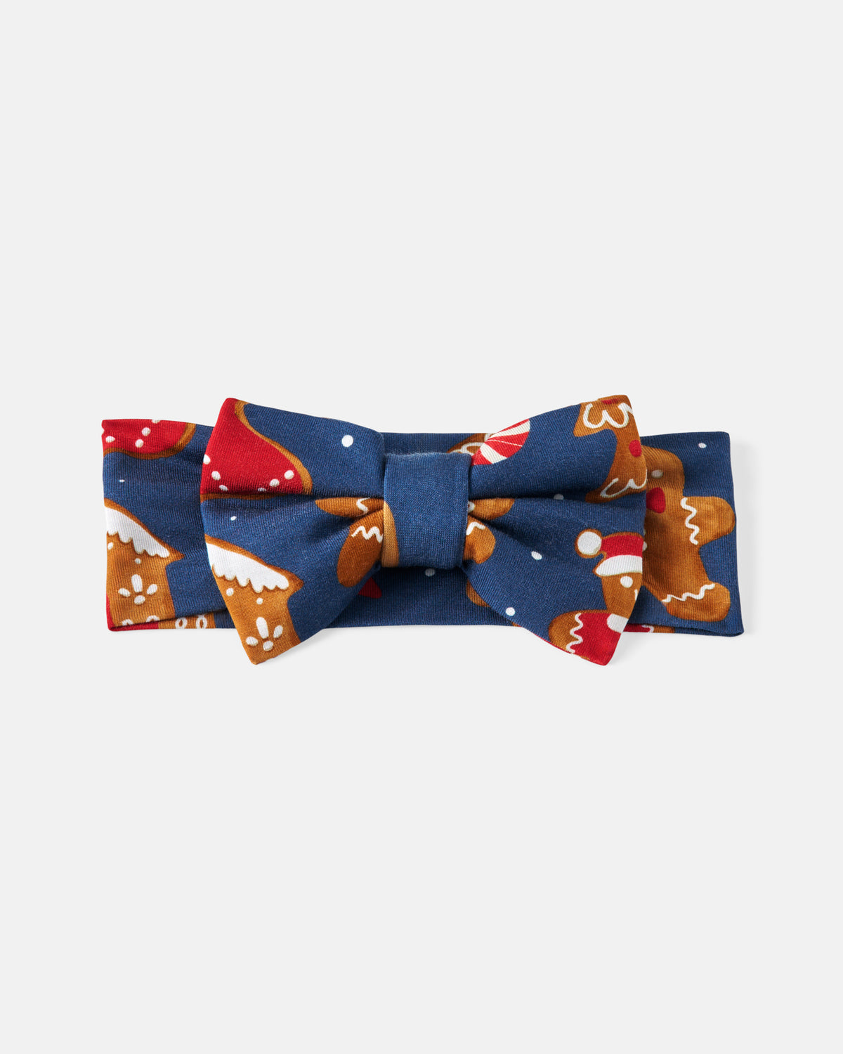 A navy blue fabric bow tie with a holiday gingerbread print, featuring gingerbread men, red ornaments, and white snow dots, displayed on a light gray background.