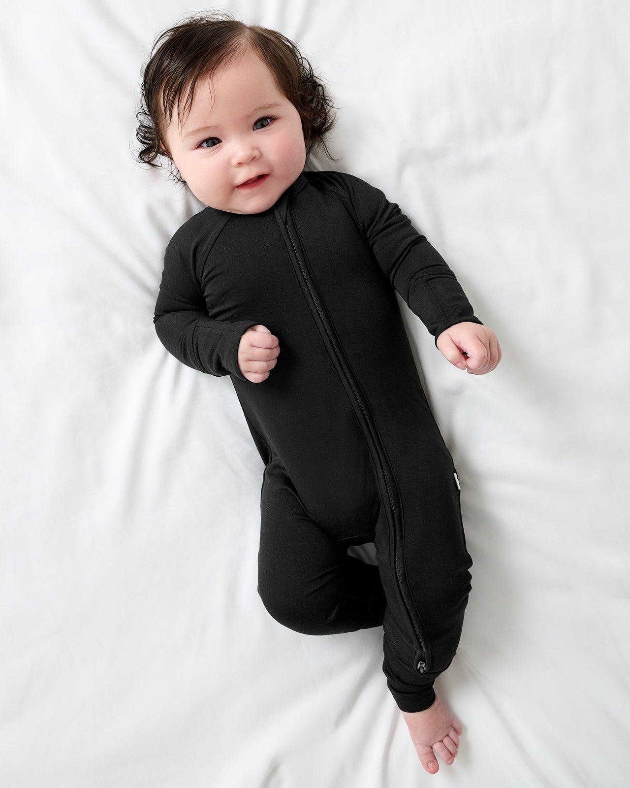 Aerial view of newborn wearing the Black Zippy