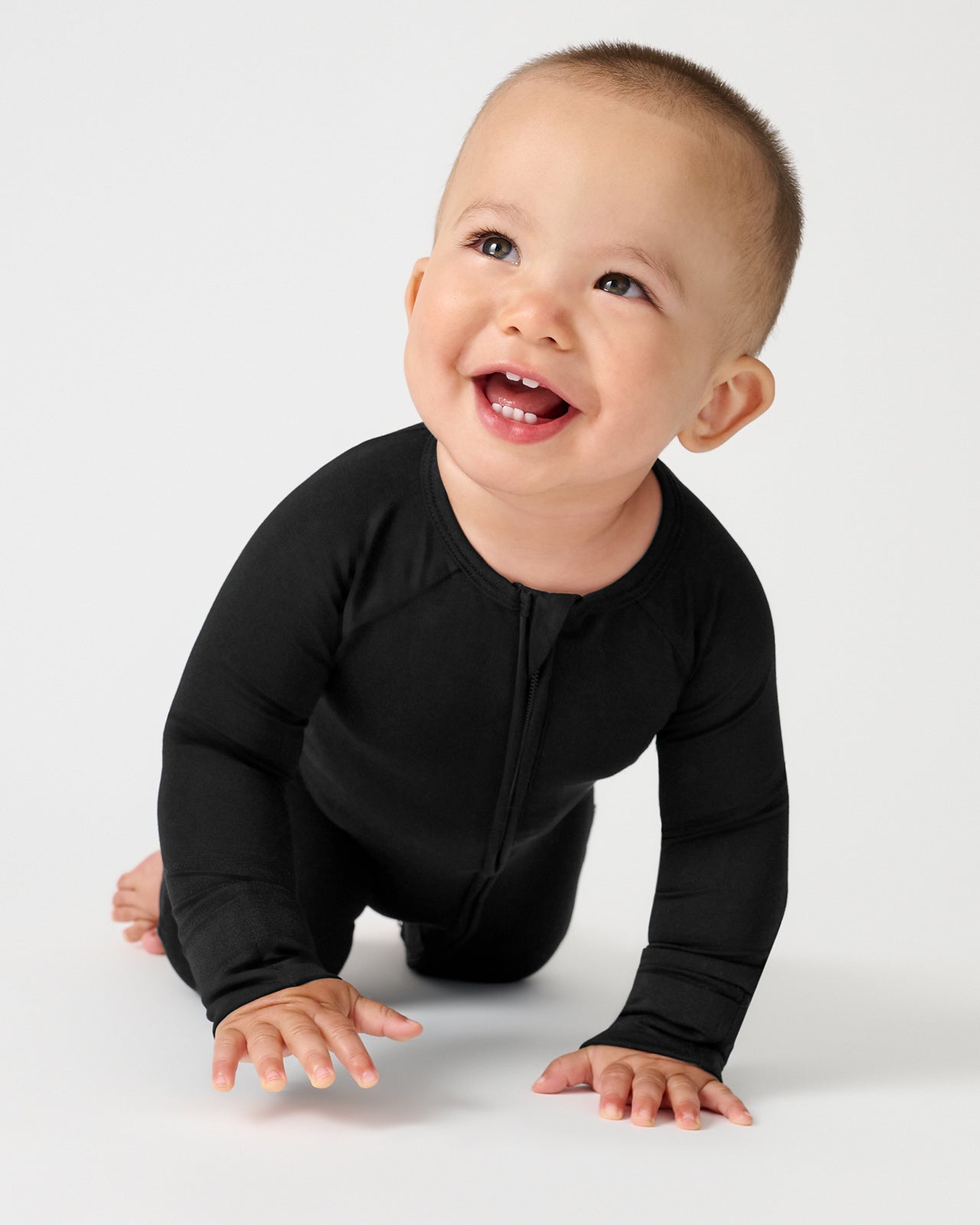 Crawling baby wearing the Black Zippy