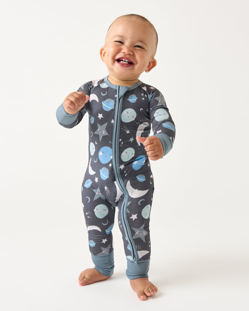 Standing child wearing the Blue To the Moon & Back Zippy
