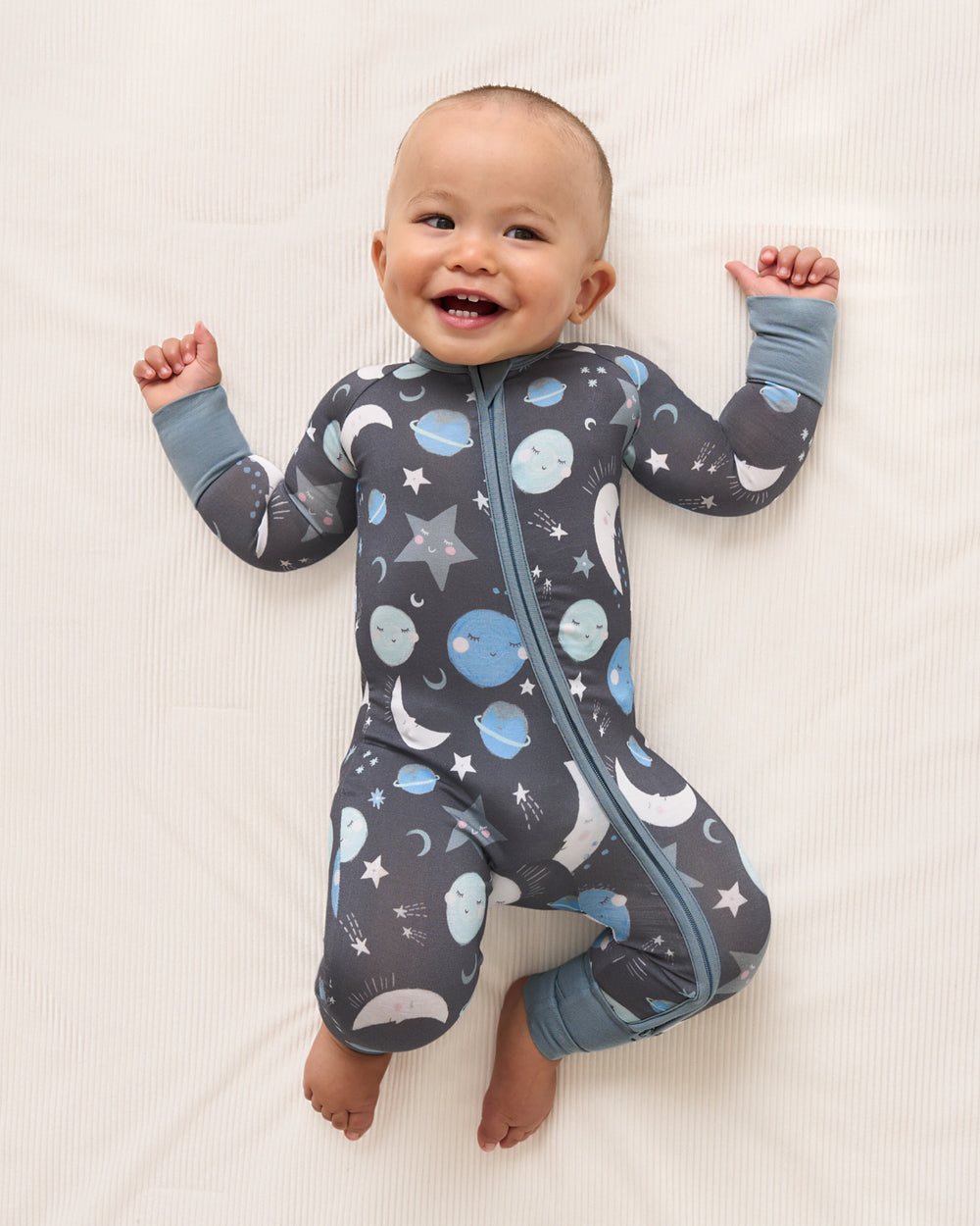 Aerial view of baby wearing the Blue To the Moon & Back Zippy