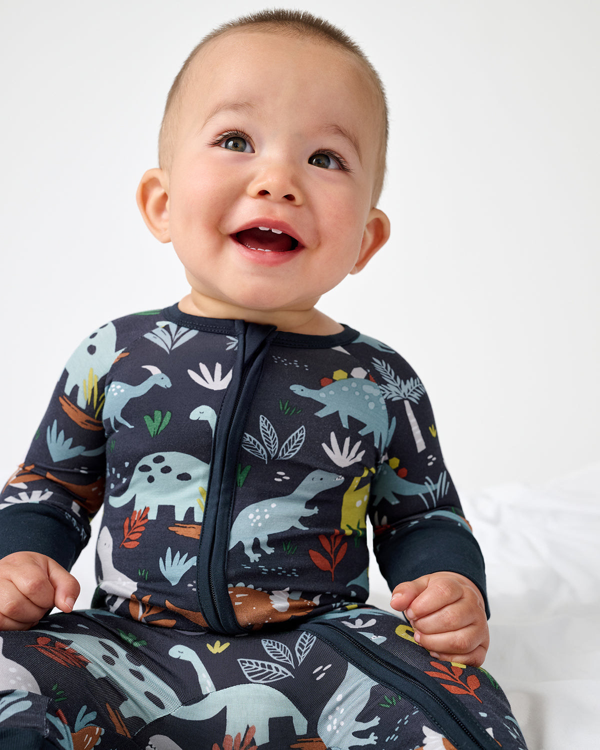 Baby boy wearing the Navy Jurassic Jungle Zippy