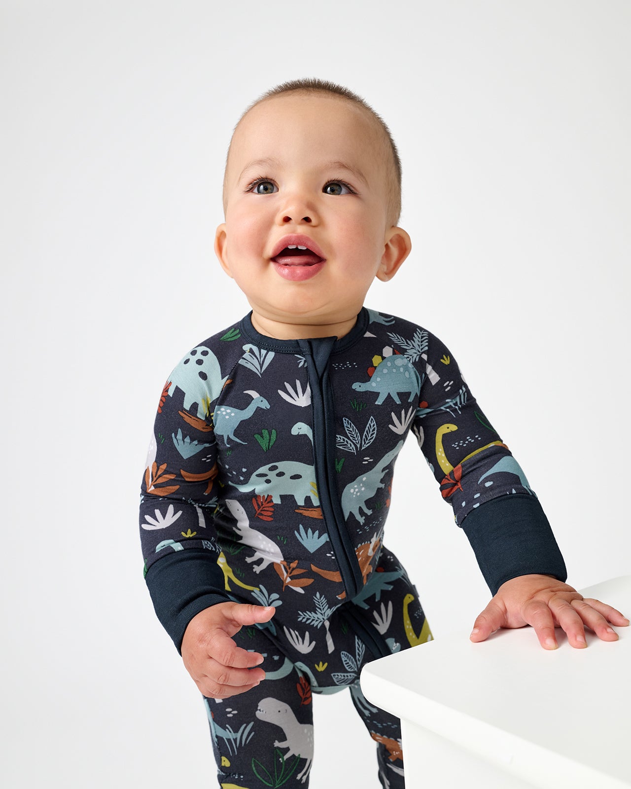 Standing baby wearing the Navy Jurassic Jungle Zippy