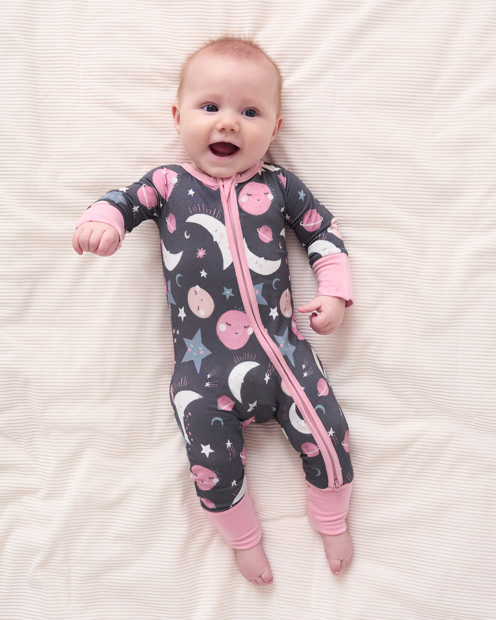 Aerial view of baby wearing the Pink To the Moon & Back Zippy