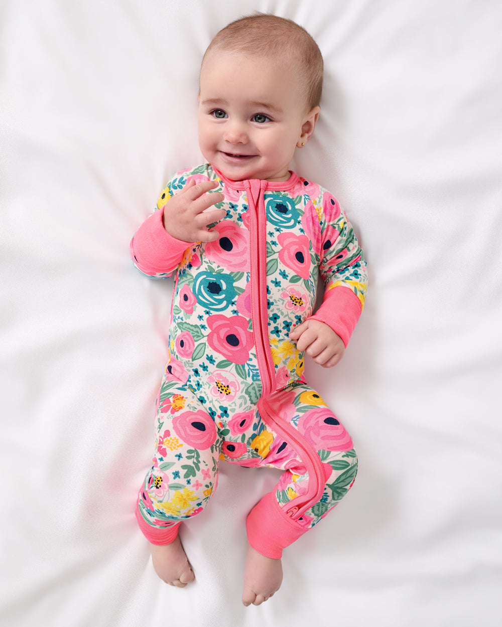 Aerial view of newborn wearing the Secret Garden Zippy