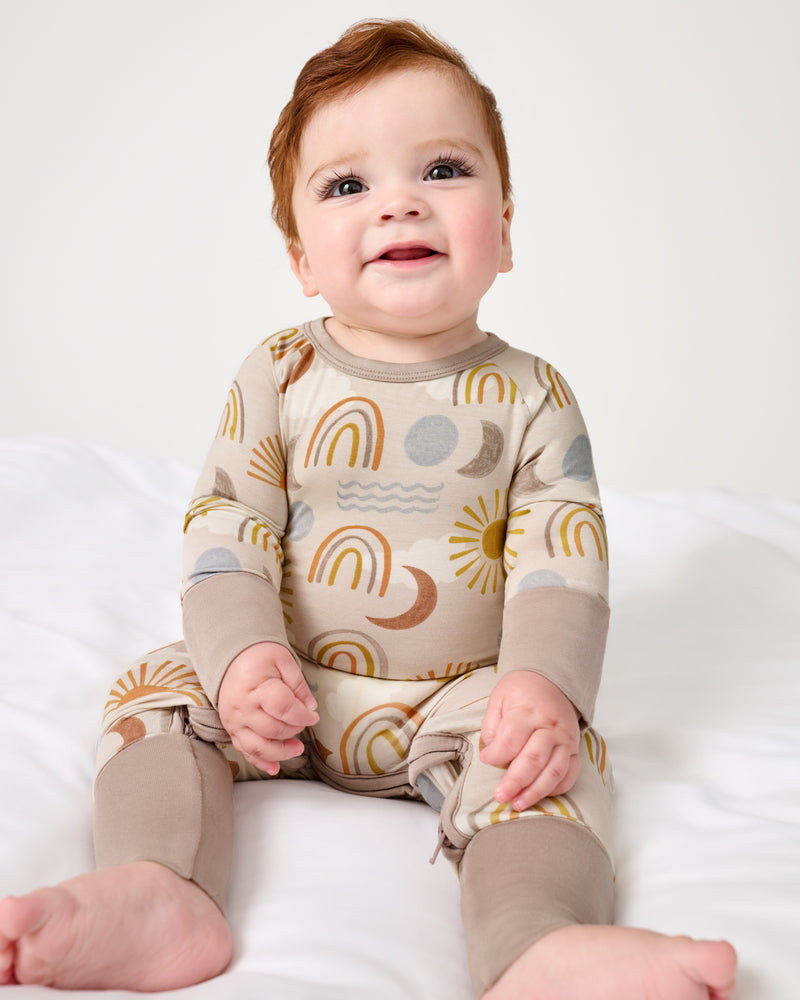 Sitting baby wearing the Desert Sunrise Crescent Zippy