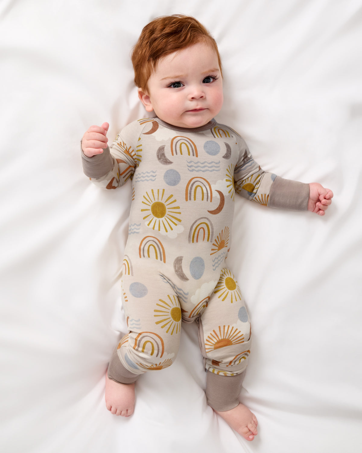 Aerial view of baby wearing the Desert Sunrise Crescent Zippy