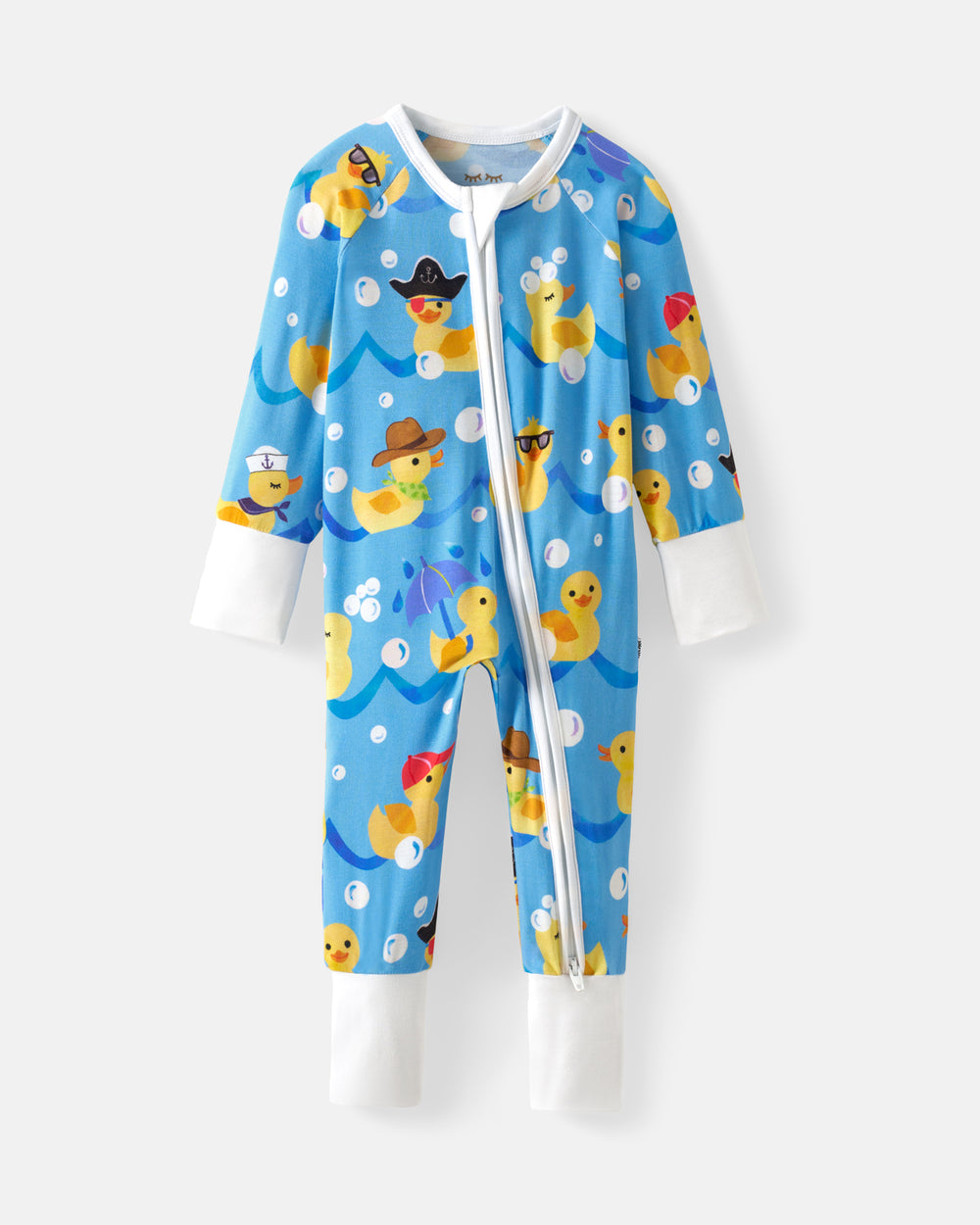 A baby's long-sleeve footless zip-up sleeper in light blue, featuring a playful print of yellow rubber ducks in various costumes on a light gray background.