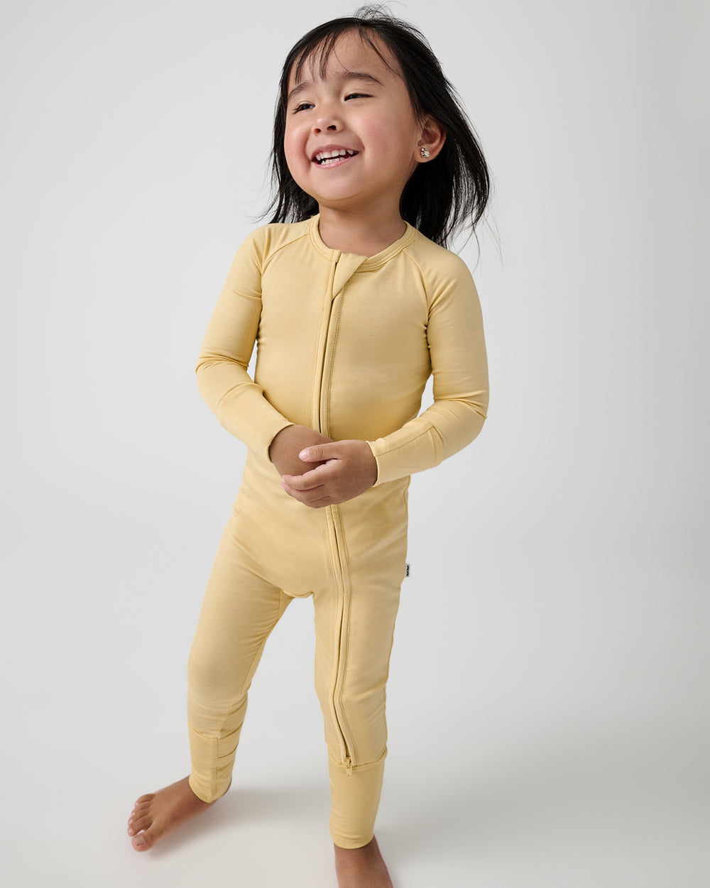 Standing toddler wearing the Sunglow Zippy