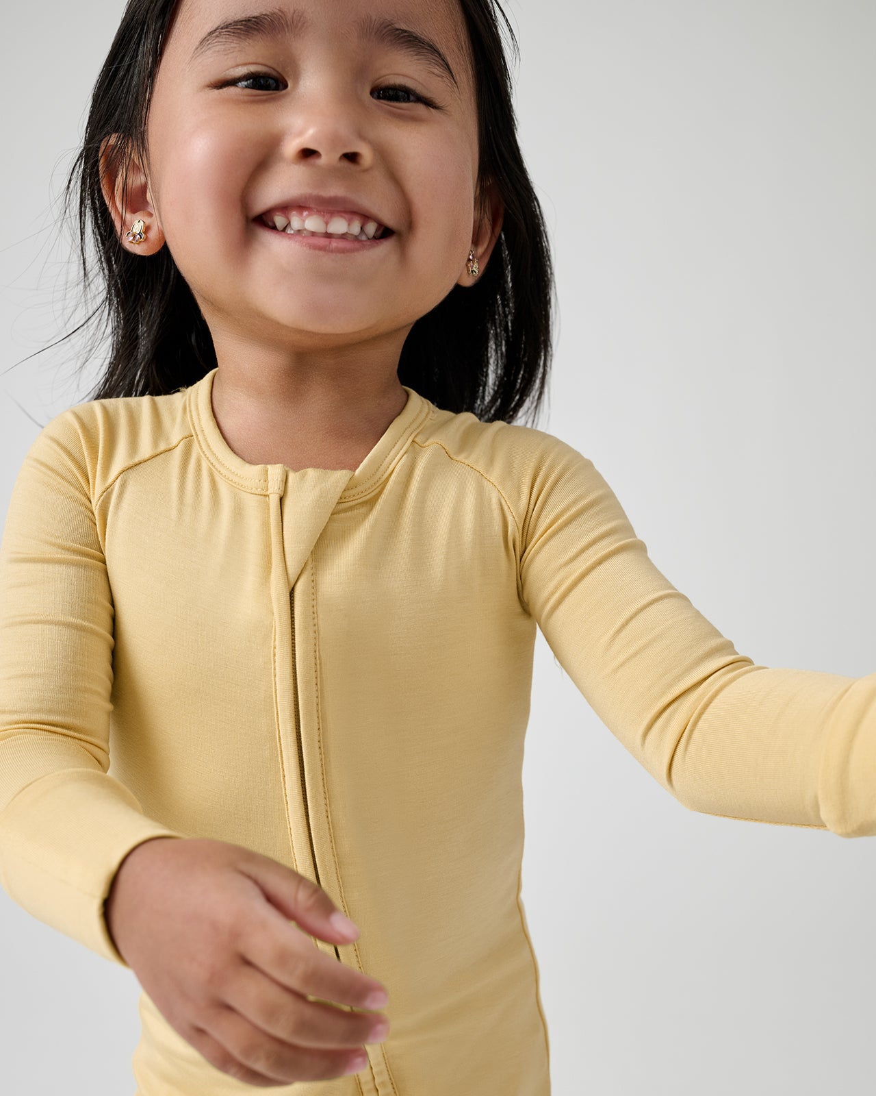 Close up of toddler wearing the Sunglow Zippy