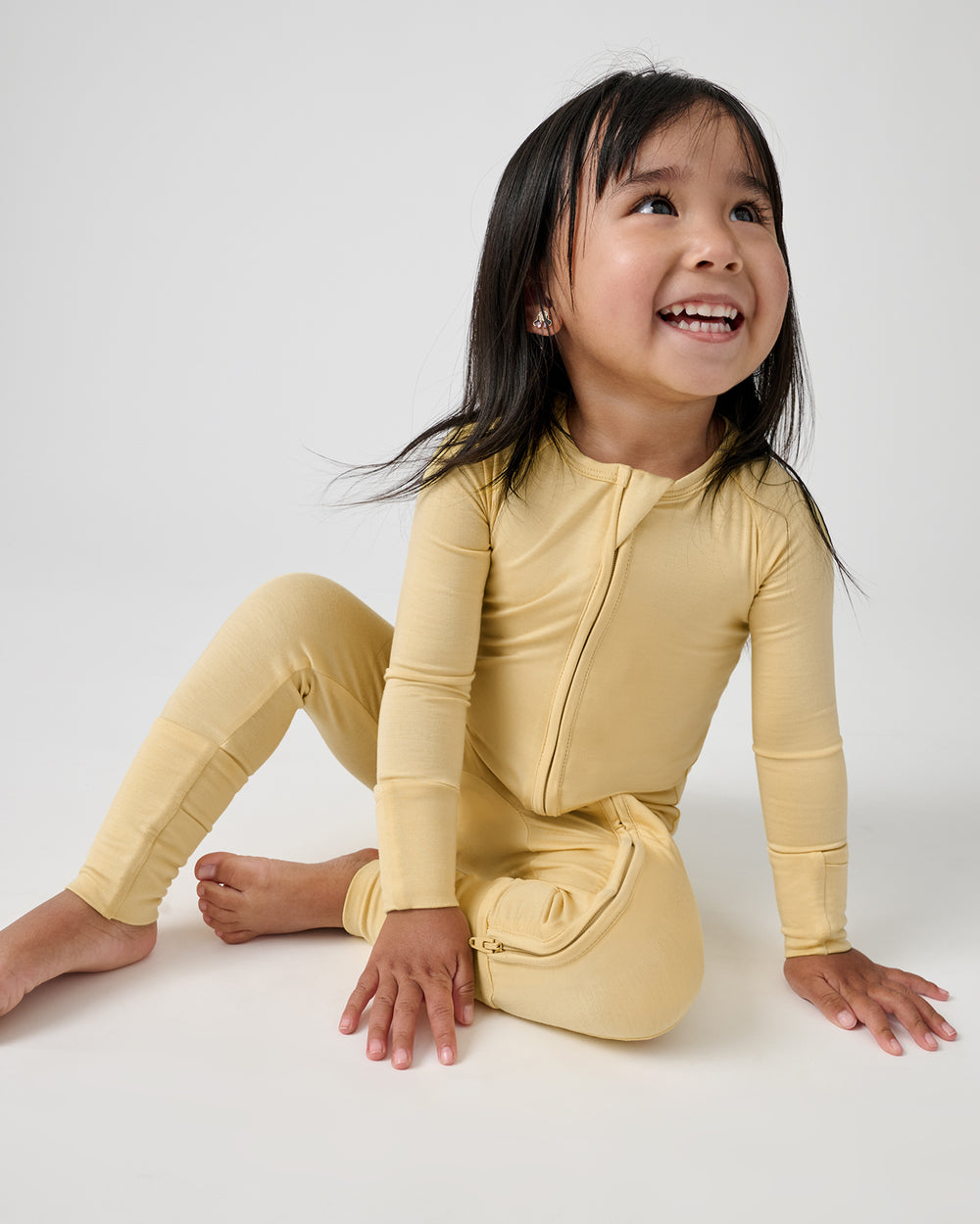 Sitting girl wearing the Sunglow Zippy