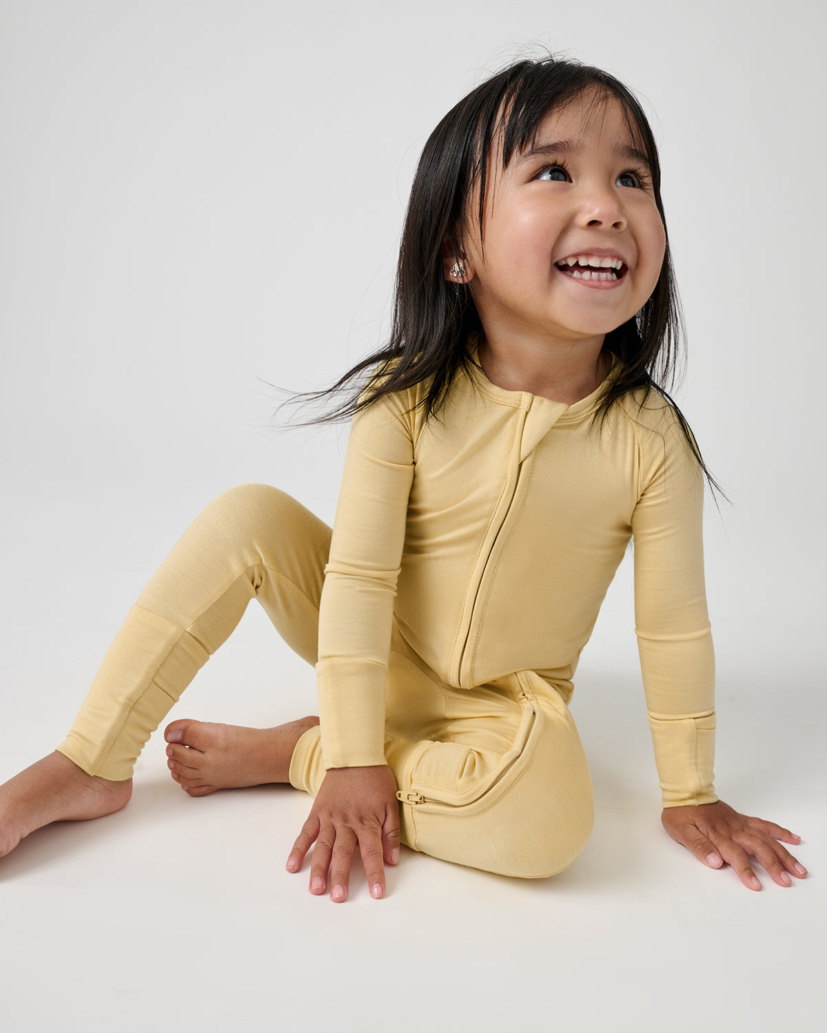 Sitting girl wearing the Sunglow Zippy