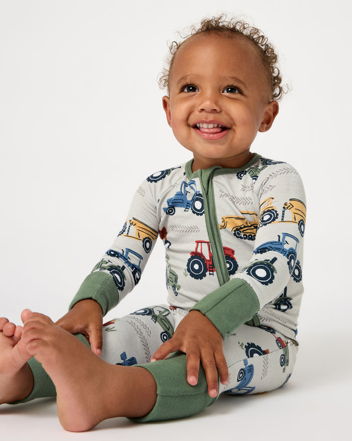 Sitting baby wearing the Tractor Tales Zippy