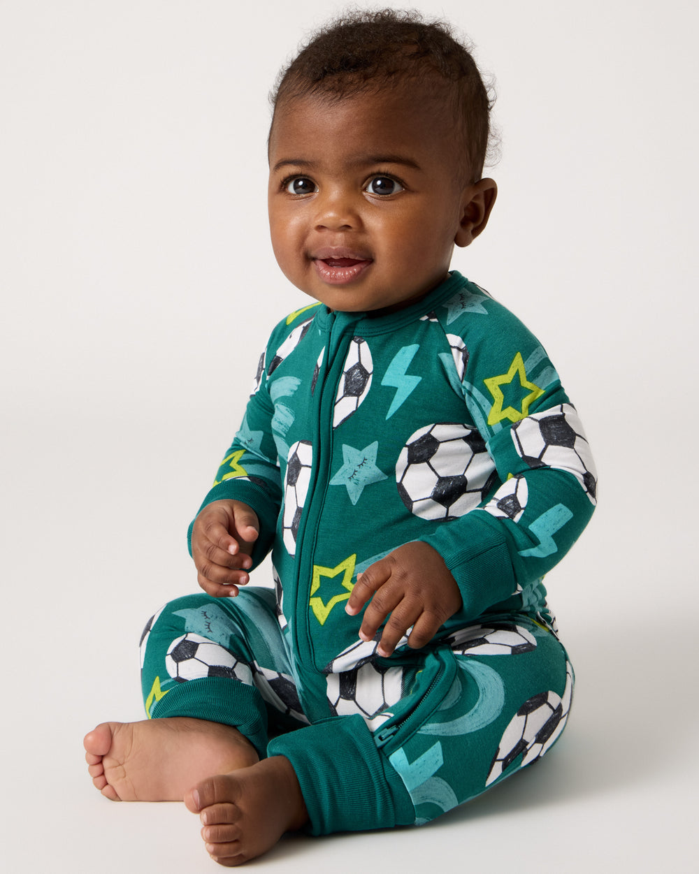 Sitting baby wearing the Soccer Stars Zippy
