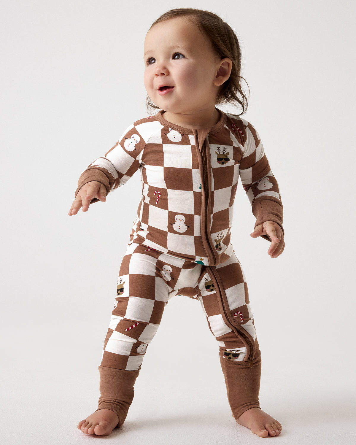 Standing baby wearing the Holiday Checks Zippy