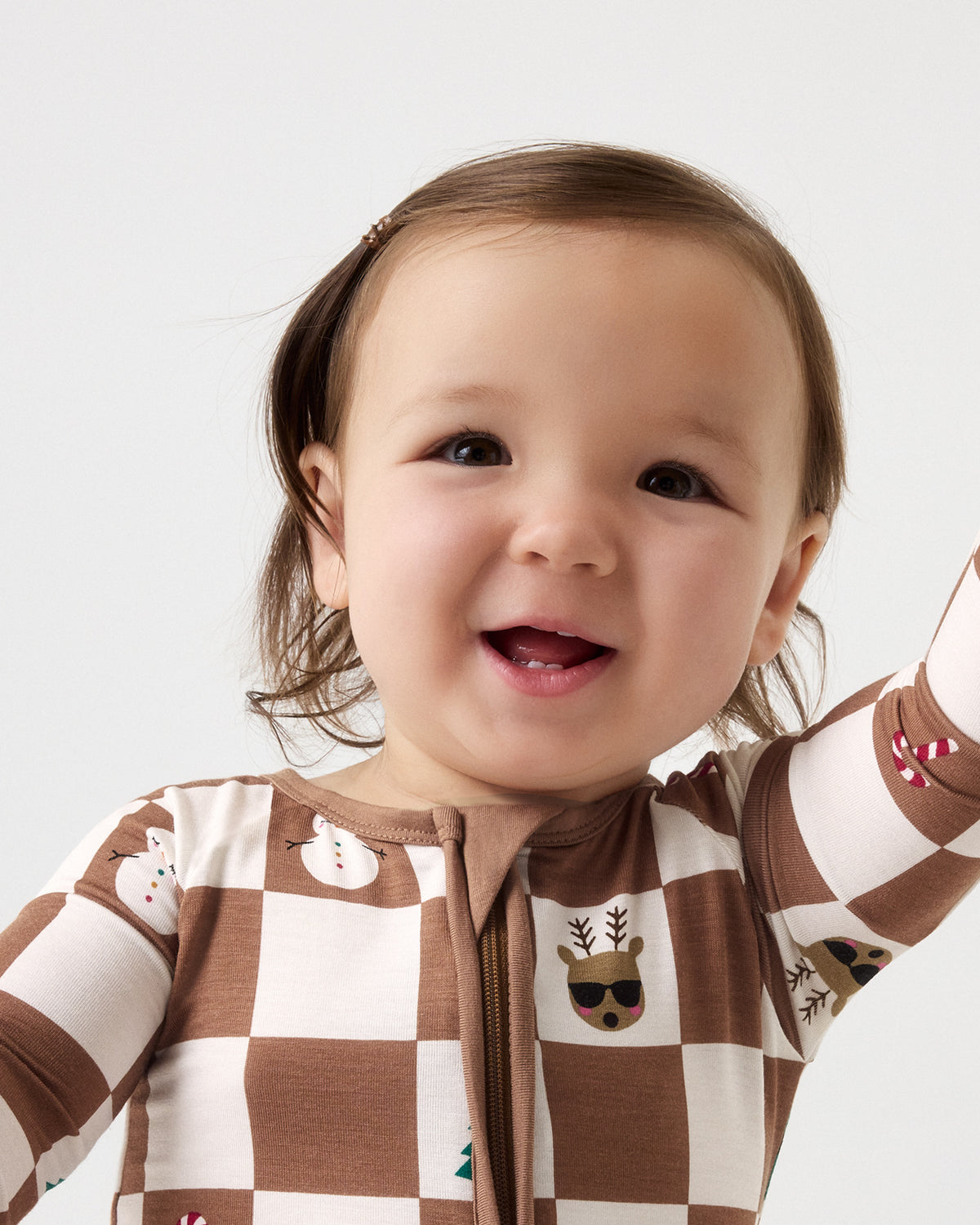 Close up of baby wearing the Holiday Checks Zippy