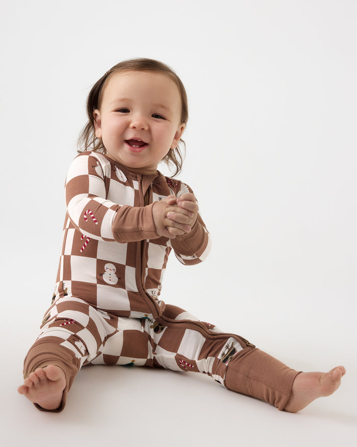 Sitting baby wearing the Holiday Checks Zippy