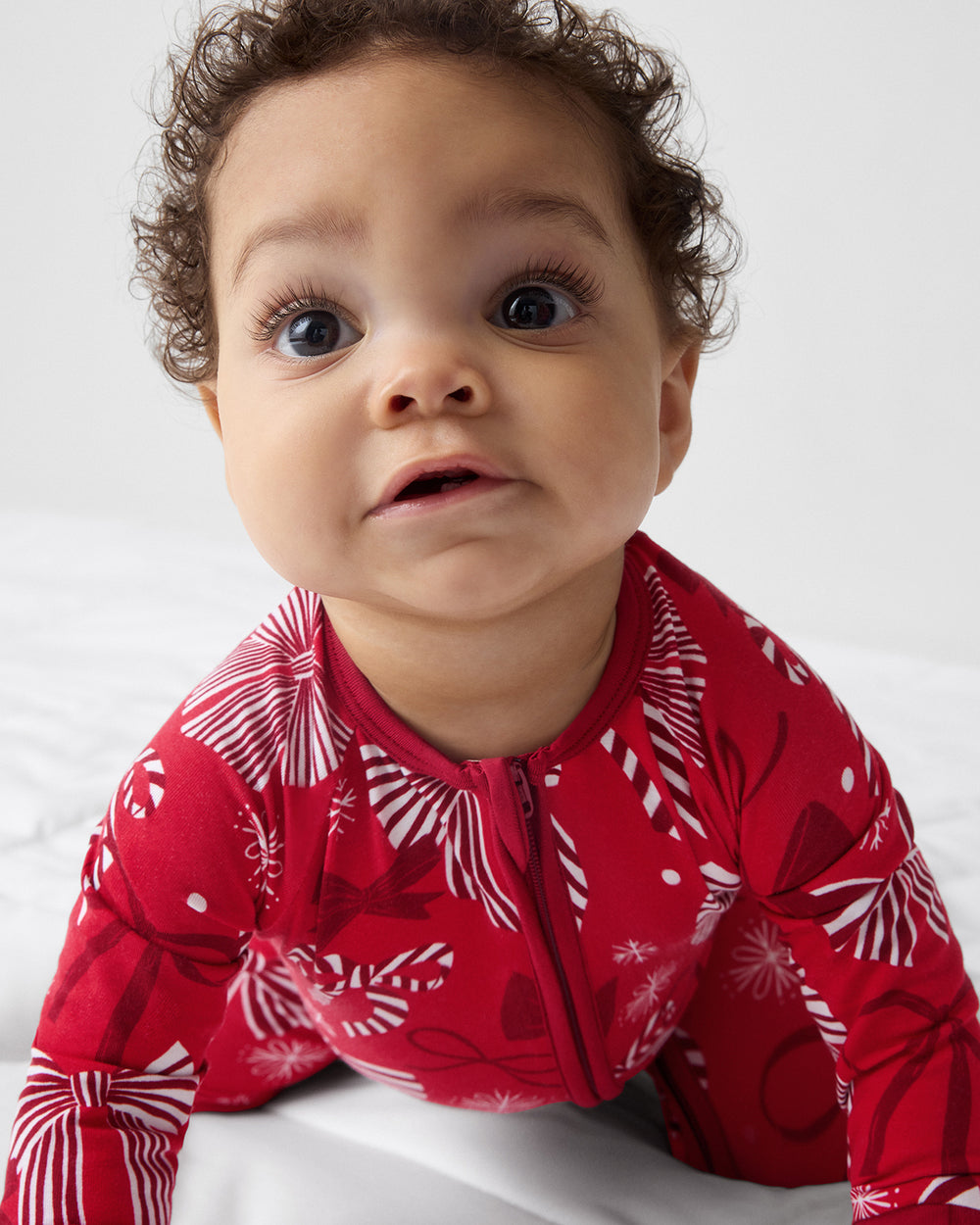 Crawling baby wearing the Holiday Bows Zippy