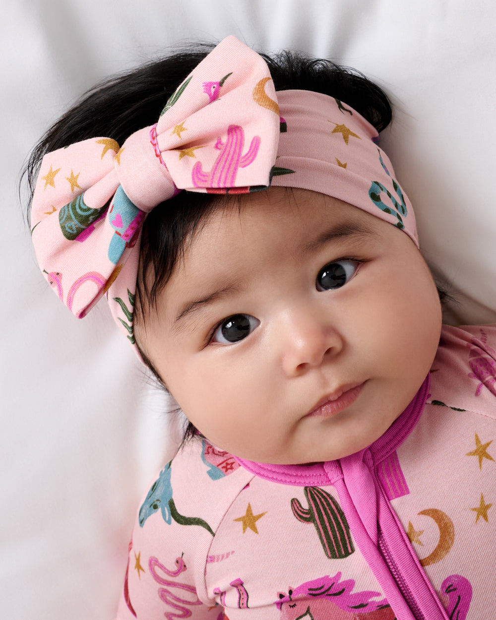 Close up of baby wearing the Pink Rancher Roundup Luxe Bow Headband