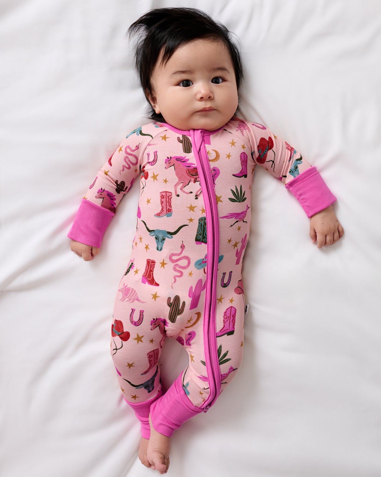 Aerial view of baby wearing the Pink Rancher Roundup Zippy
