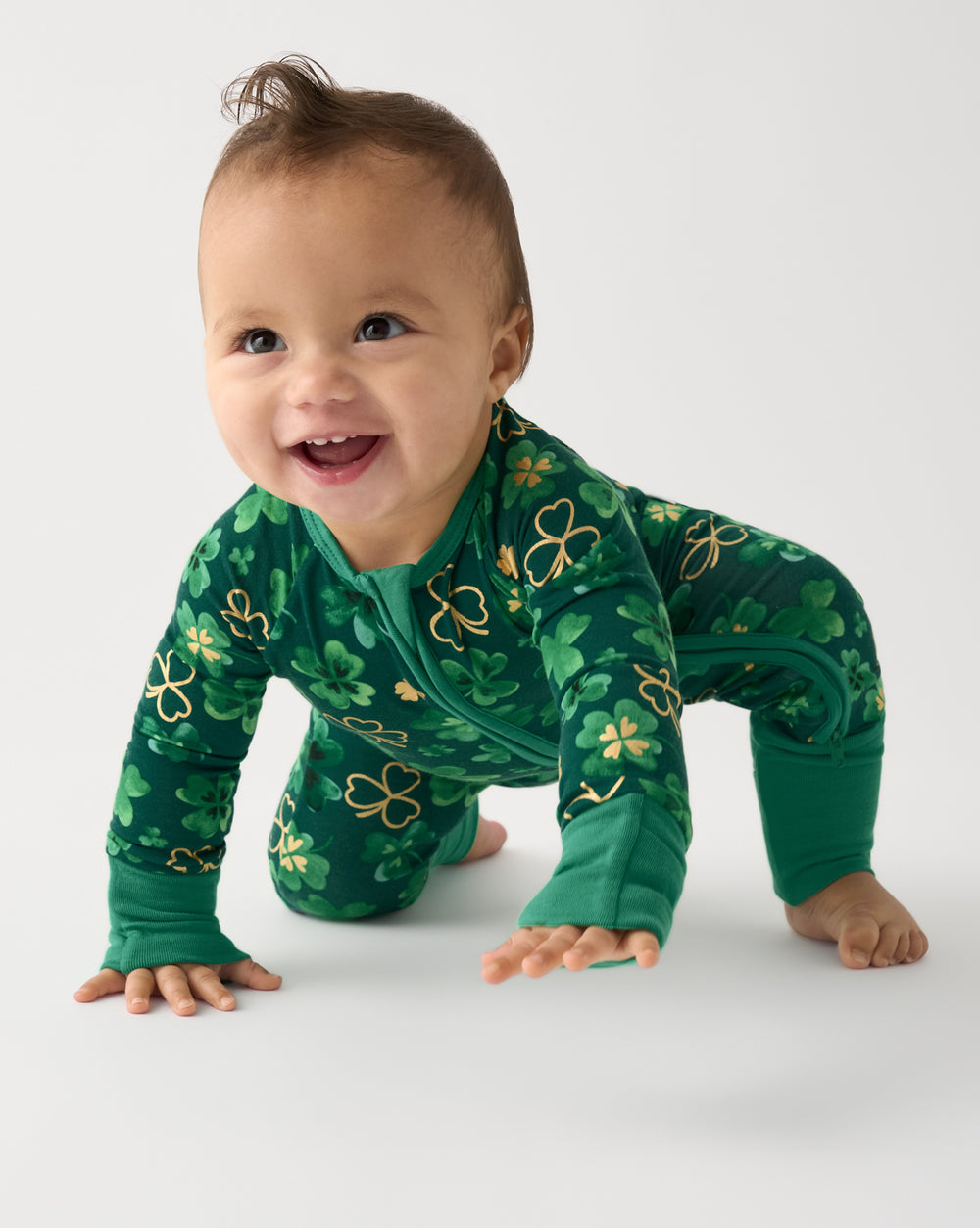 Crawling baby wearing the Clover Cuties Zippy