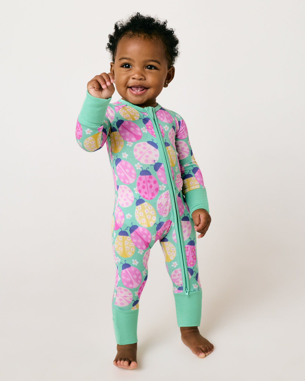 Standing child wearing the Ladybug Meadow Zippy