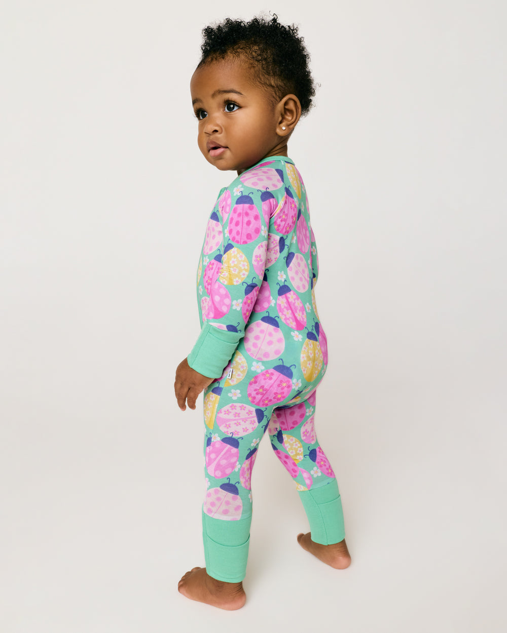 Standing girl wearing the Ladybug Meadow Zippy 