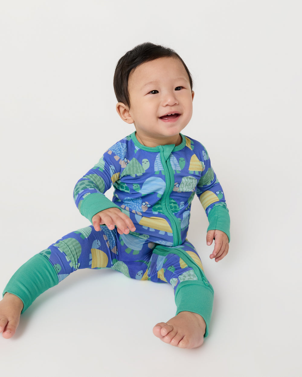 Sitting baby wearing the Shell Parade Zippy