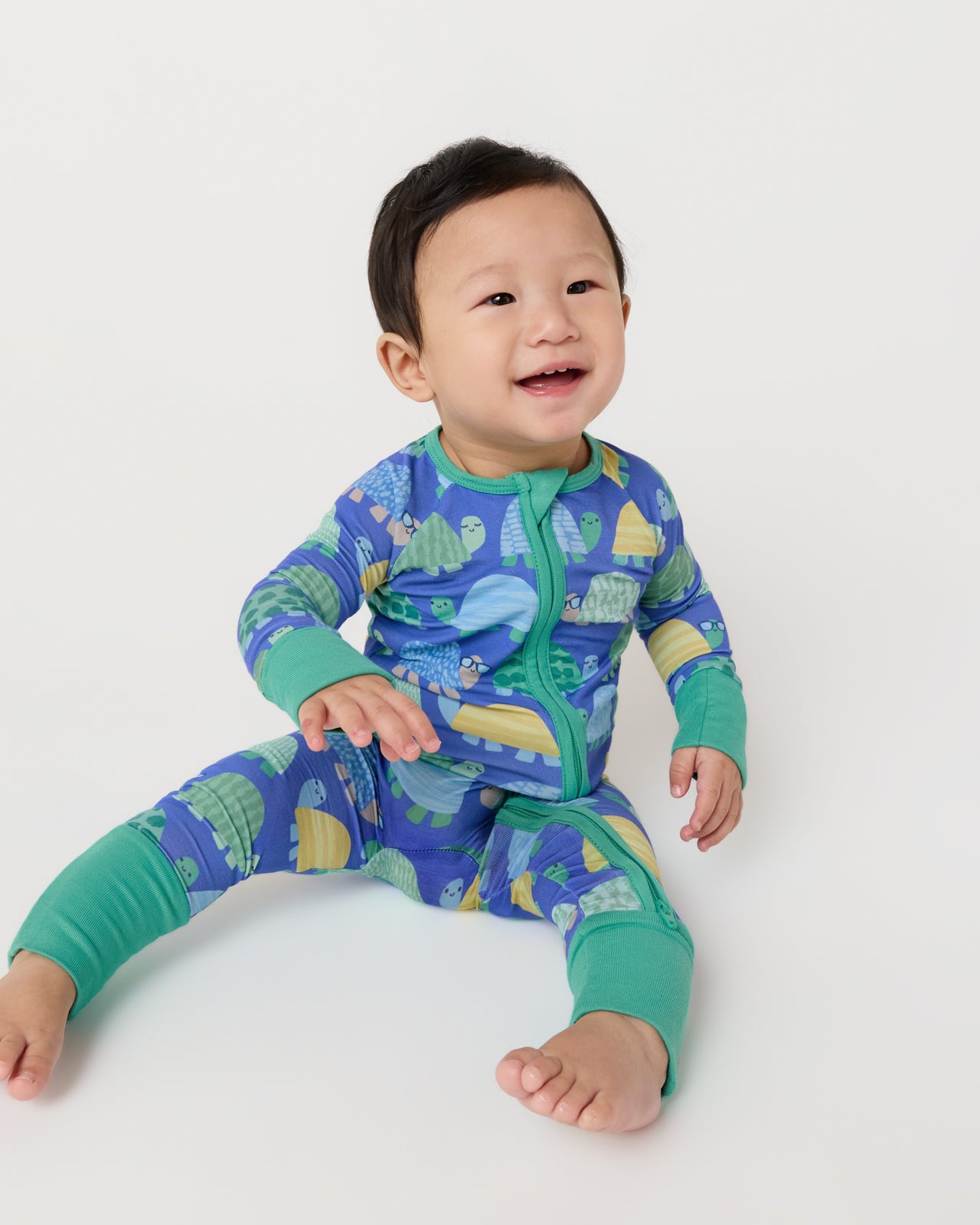 Sitting baby wearing the Shell Parade Zippy