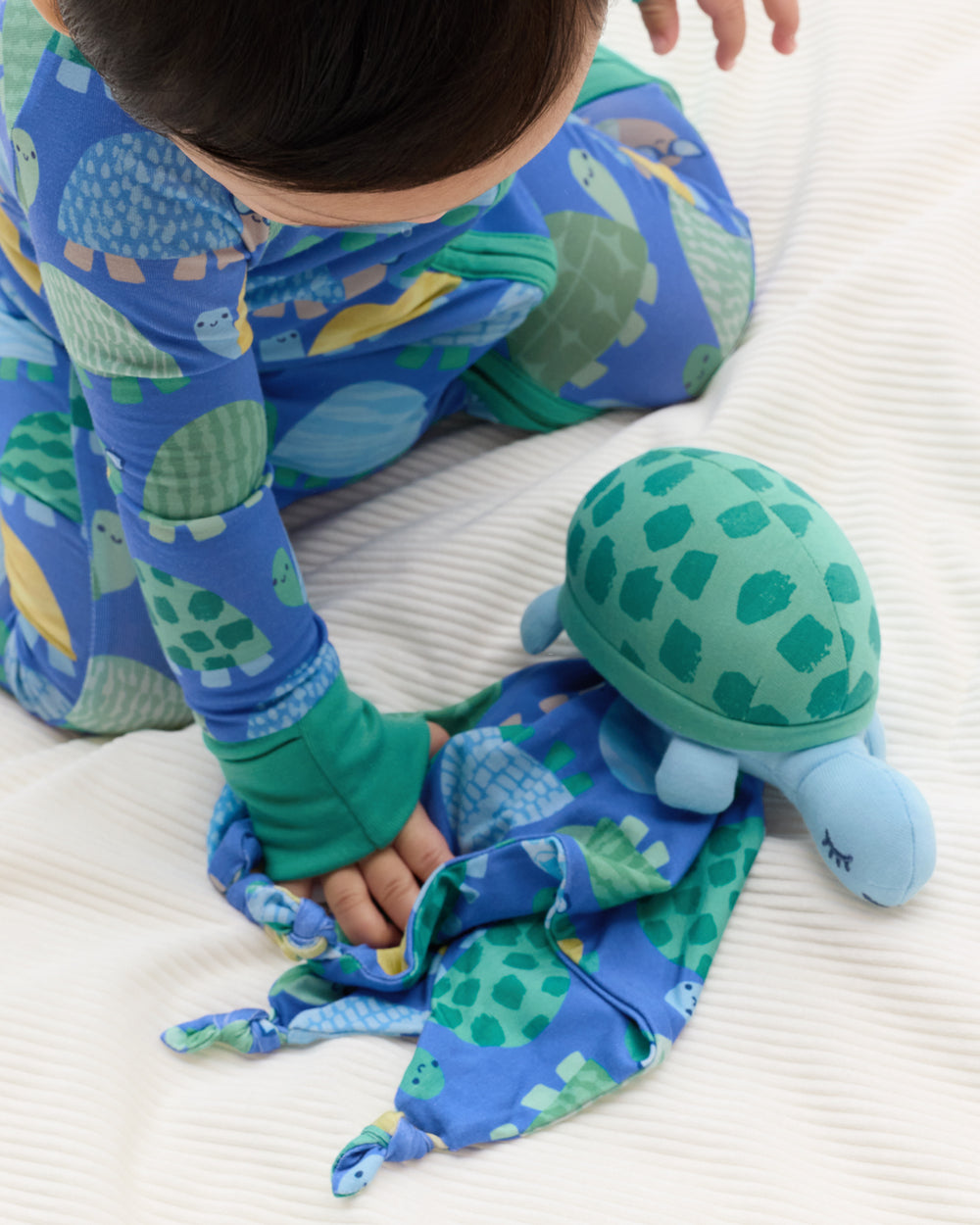Baby playing with the Ty the Turtle Sleepyhead Lovey