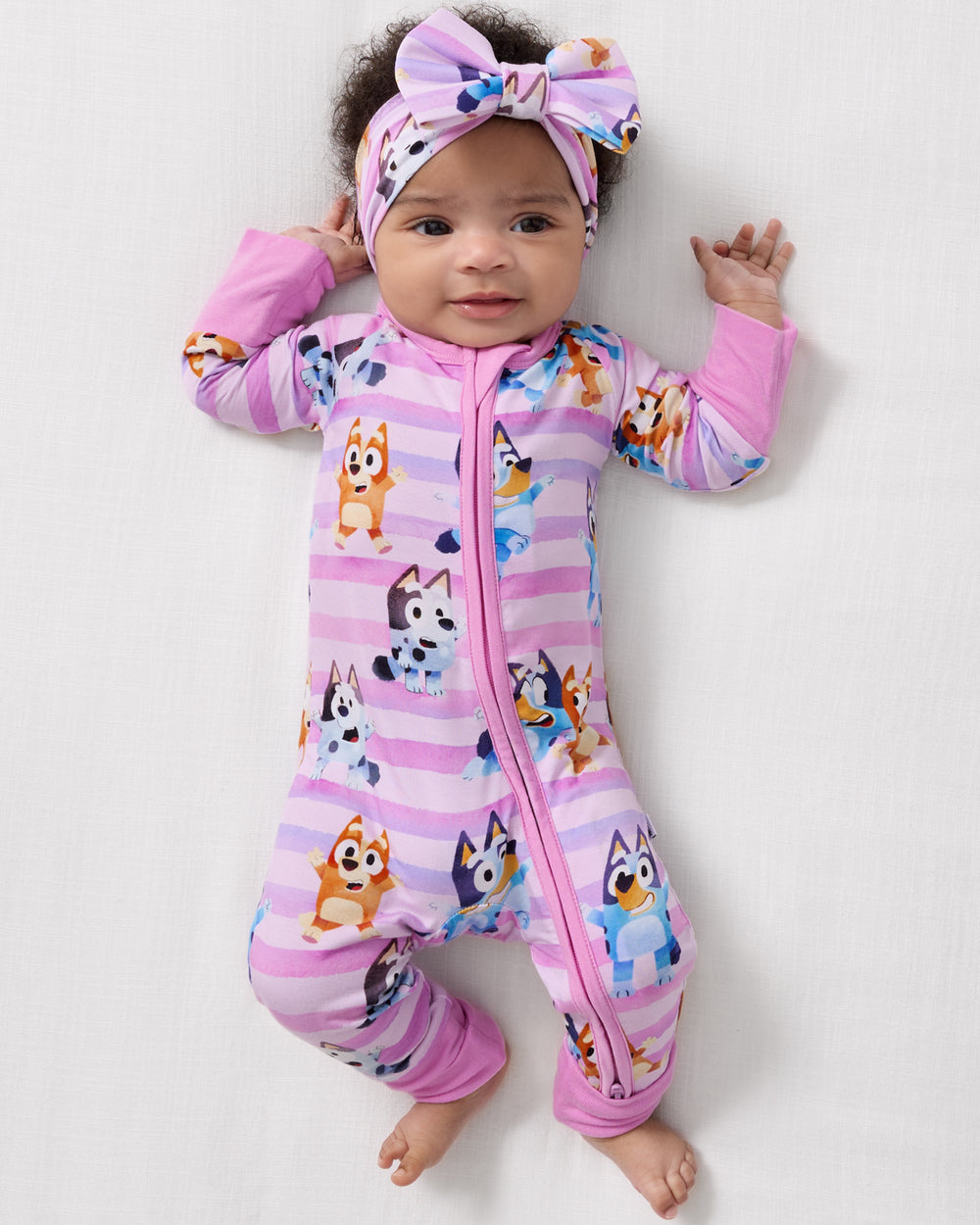 Aerial view of baby wearing the Pink Bluey Dance All Day Zippy and Luxe Bow Headband