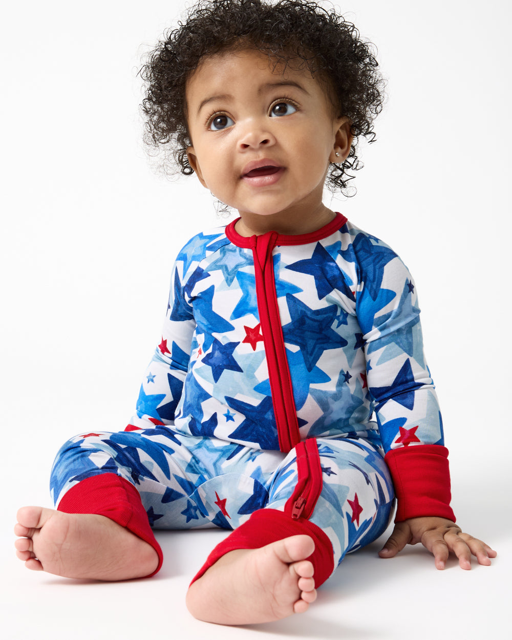 Sitting baby wearing a Starry Splash Zippy