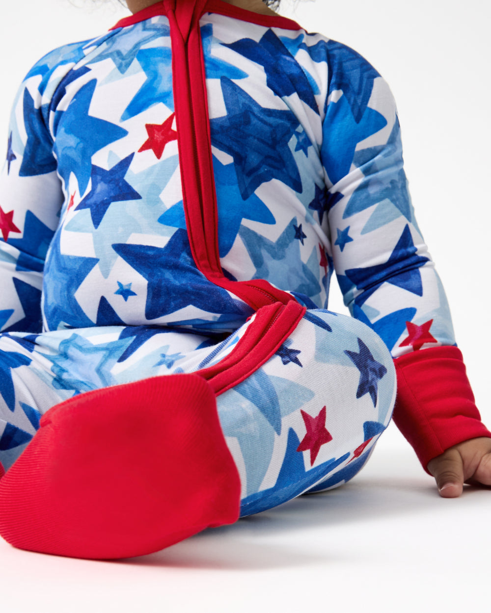 Close up of baby wearing the Starry Splash Zippy with the fold over booties on 