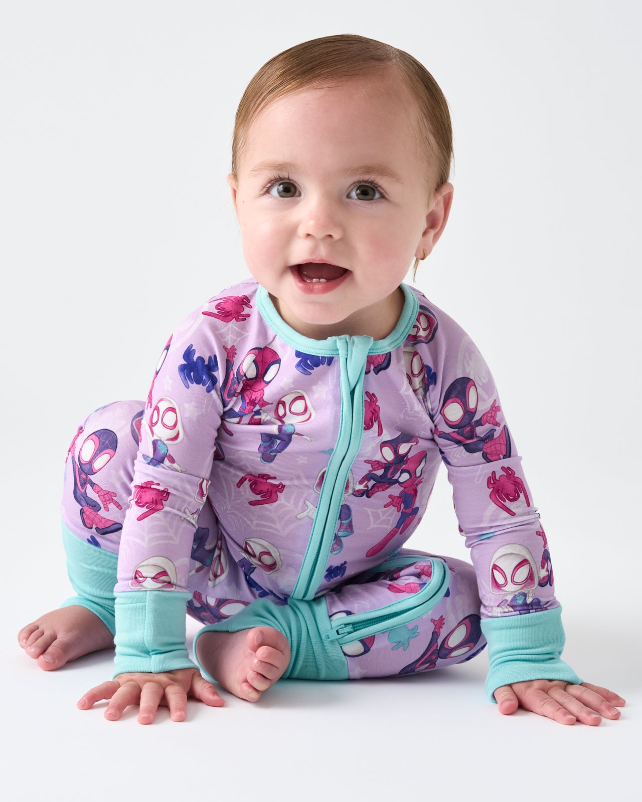 Sitting baby wearing the Spidey & Friends Tiny Webs Zippy