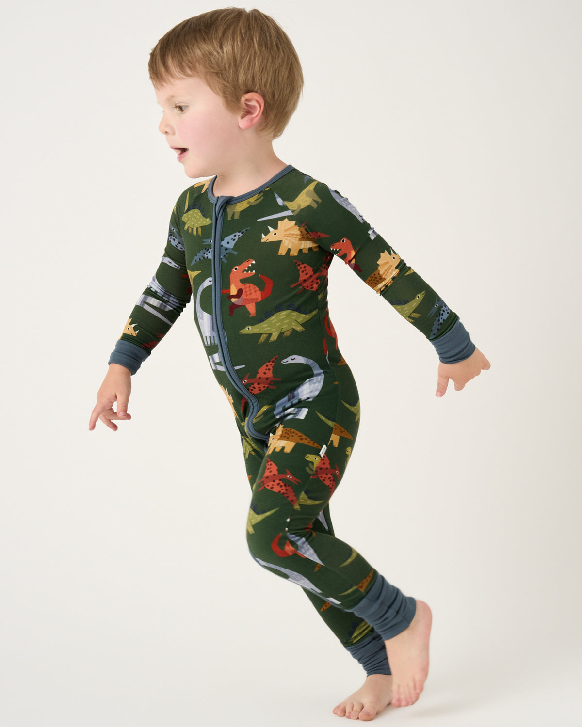 Running child wearing the Green Roar & Explore Zippy