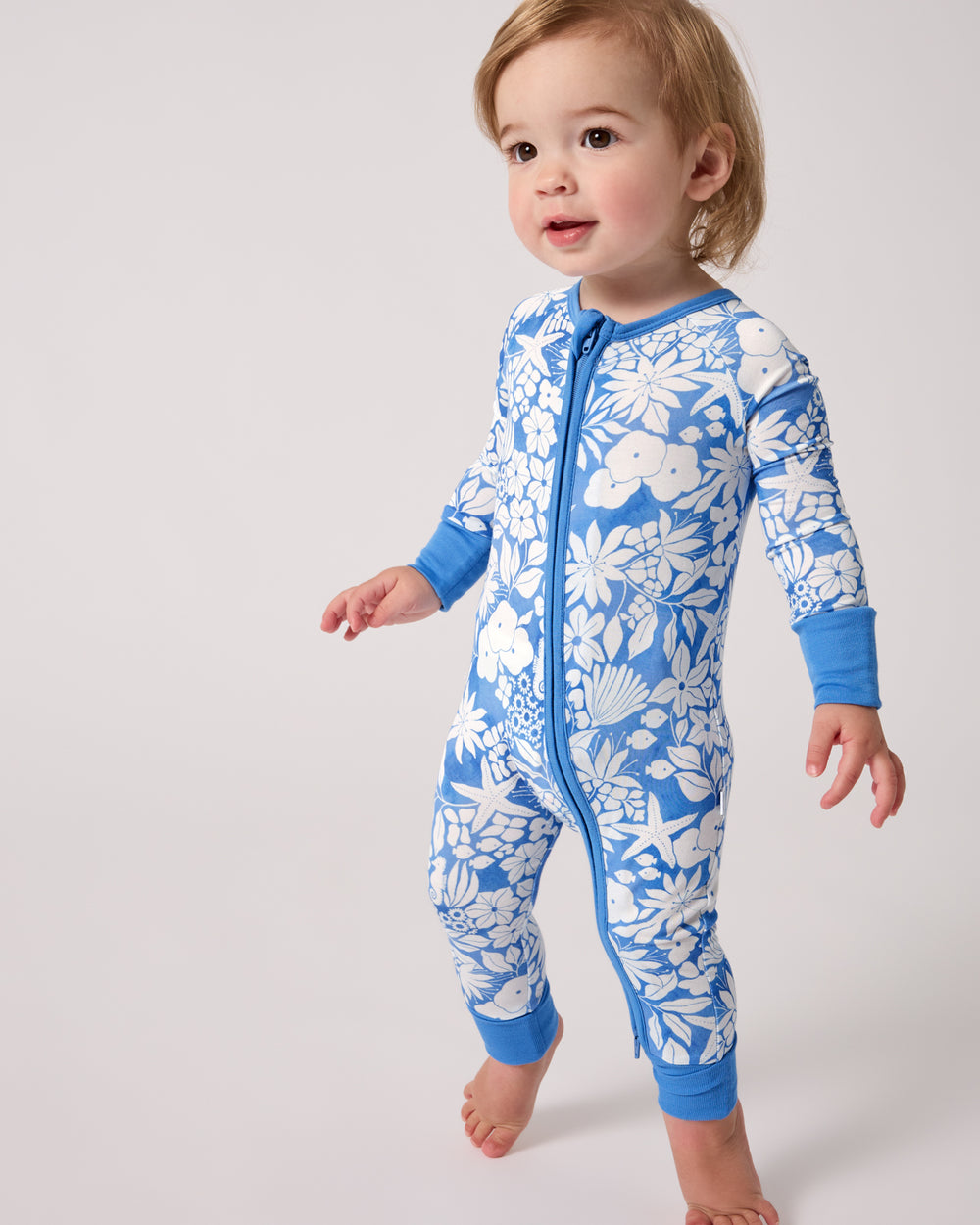 Standing toddler wearing the Azure Garden Zippy