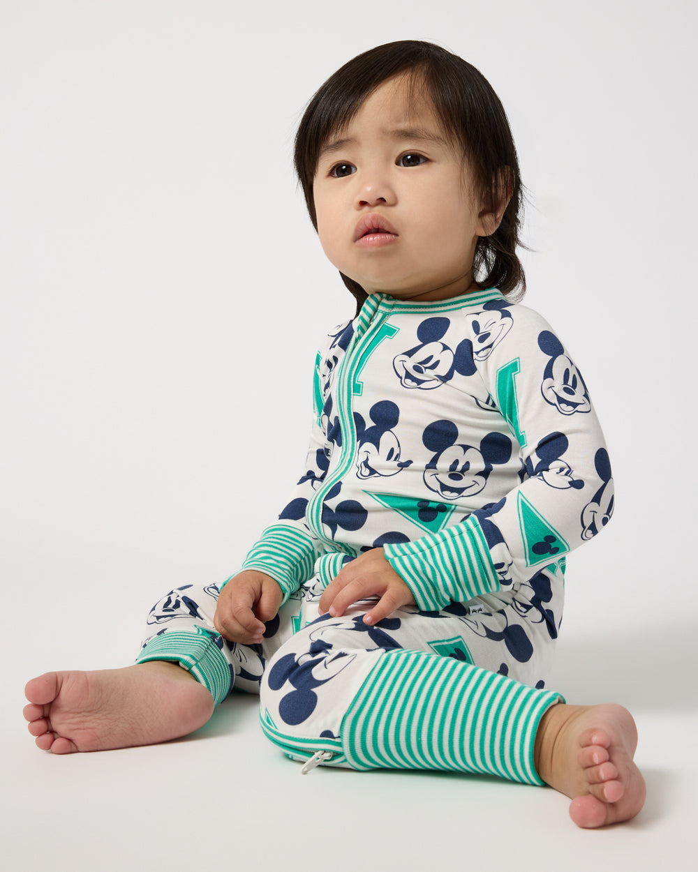 Sitting baby wearing the Disney Varsity Mickey Mouse Zippy