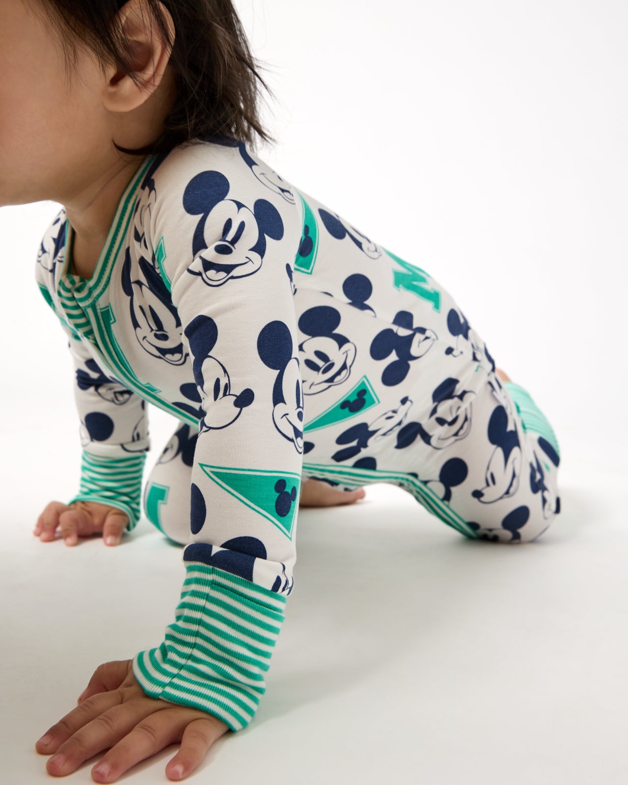 Crawling baby wearing the Disney Varsity Mickey Mouse Zippy
