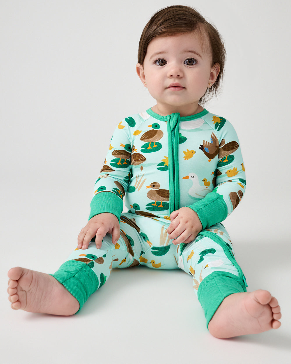 Sitting baby wearing the Puddle Jumpers Zippy