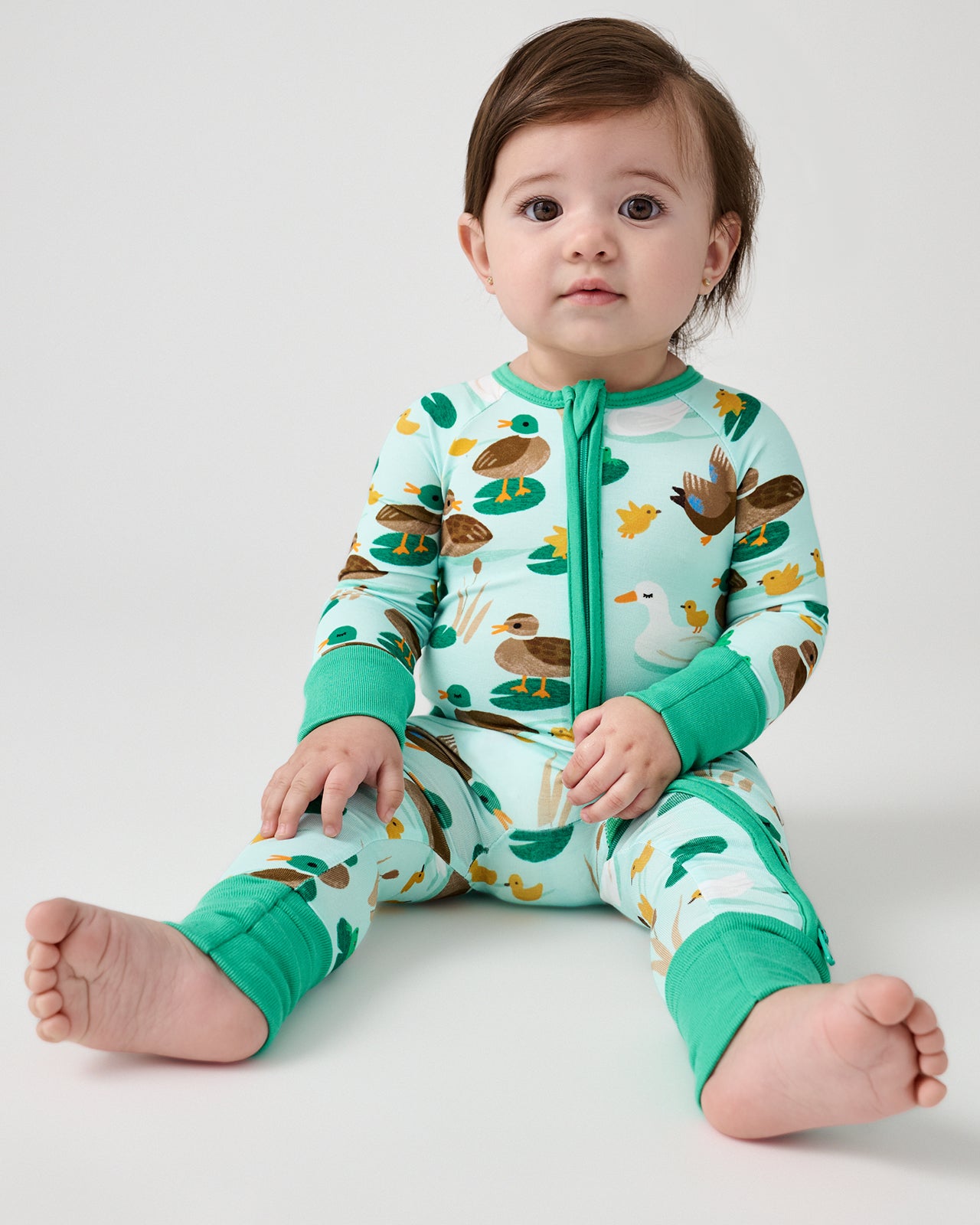 Sitting baby wearing the Puddle Jumpers Zippy