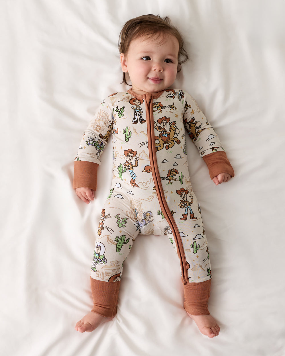 Aerial view of baby wearing the Disney & Pixar Woody's Wild West Zippy