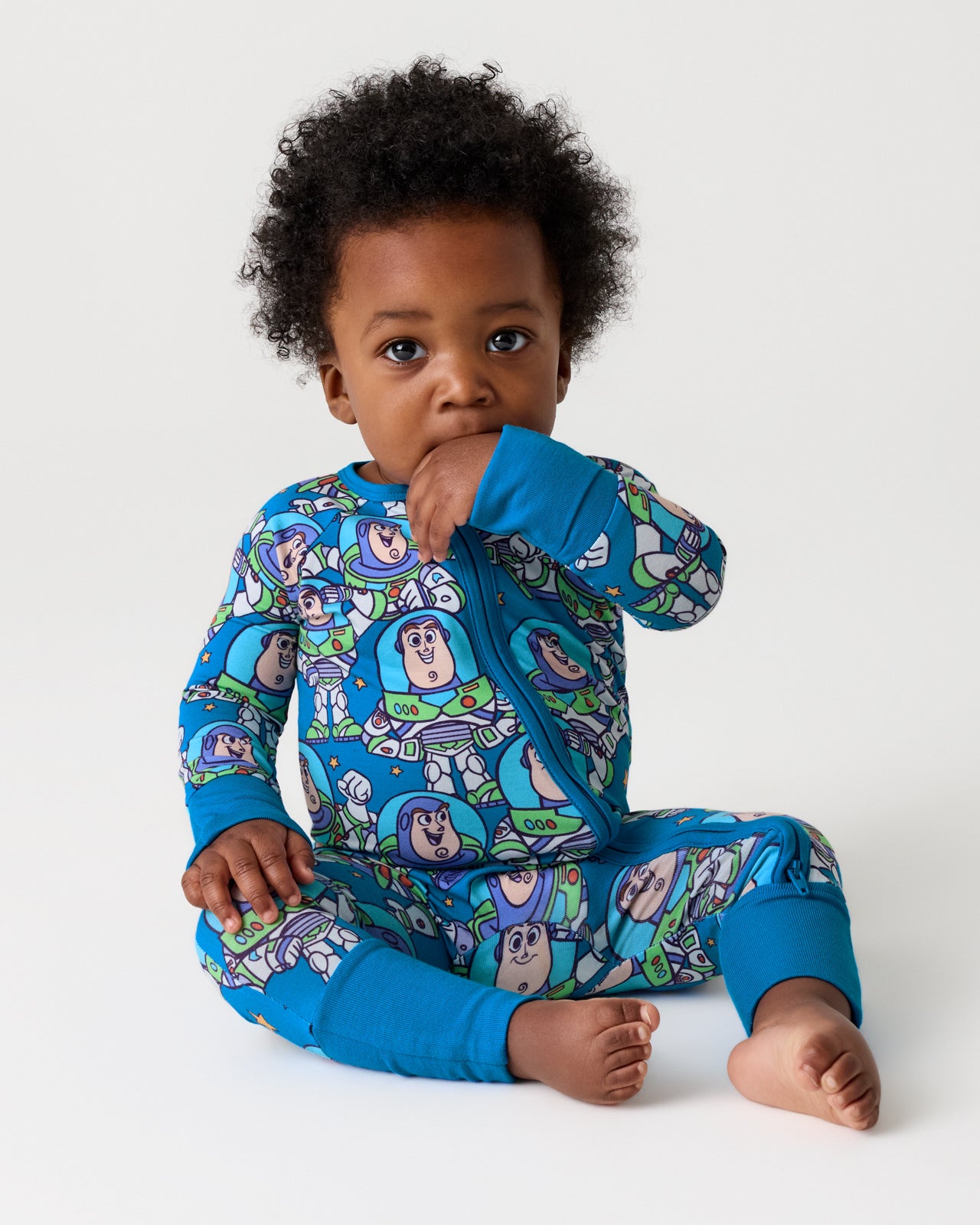 Sitting child wearing the Disney & Pixar Buzz's Cosmic Crew Zippy