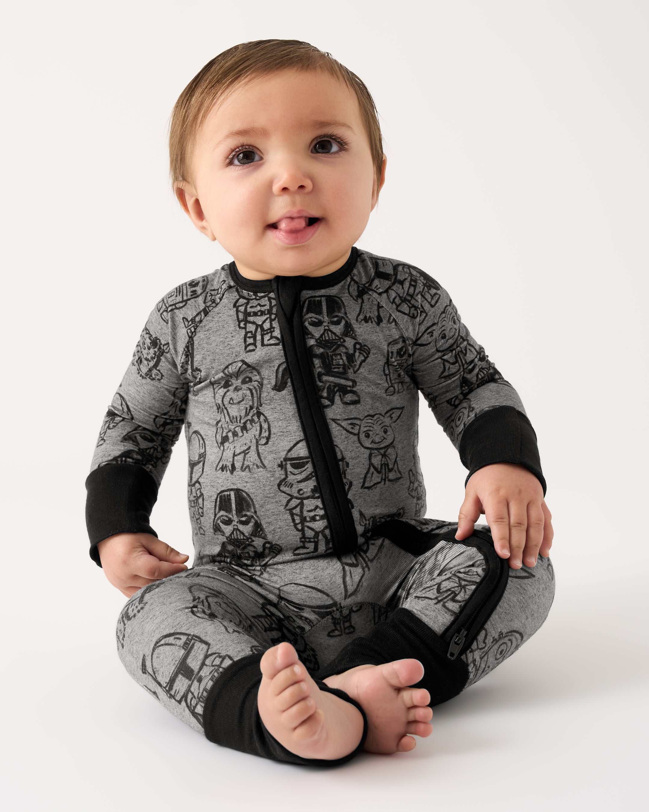 Sitting baby wearing the Star Wars Far, Far, Away Friends Zippy