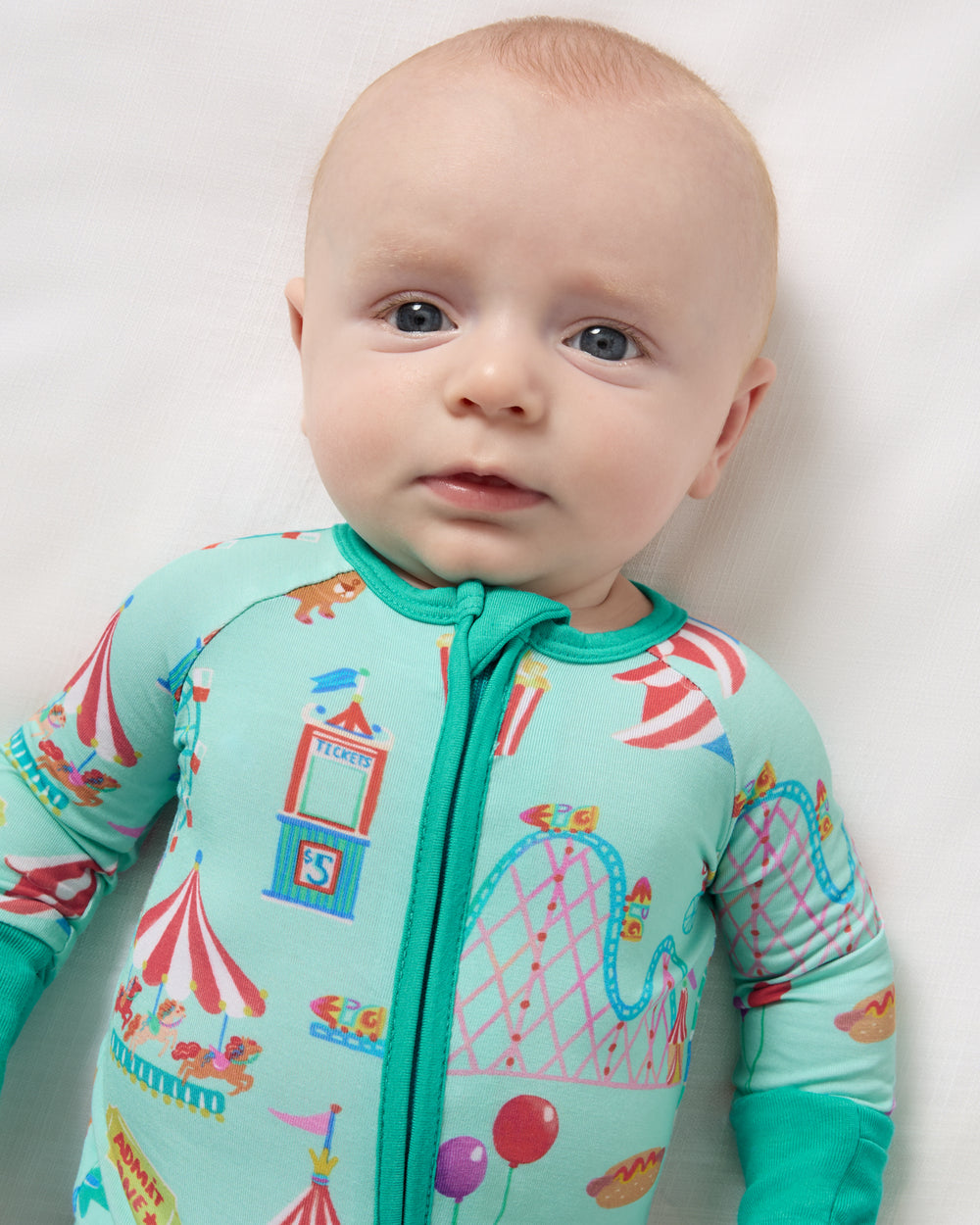 Close up of newborn wearing the Fizzy Fair Zippy