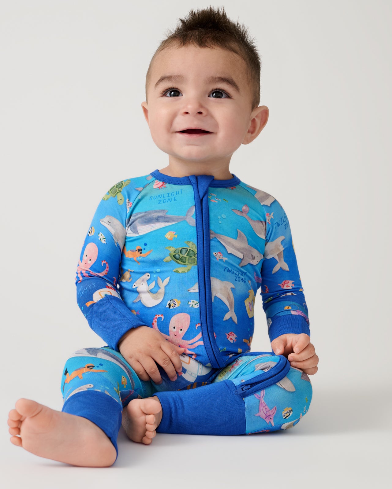 Sitting baby wearing the Underwater Discovery Zippy
