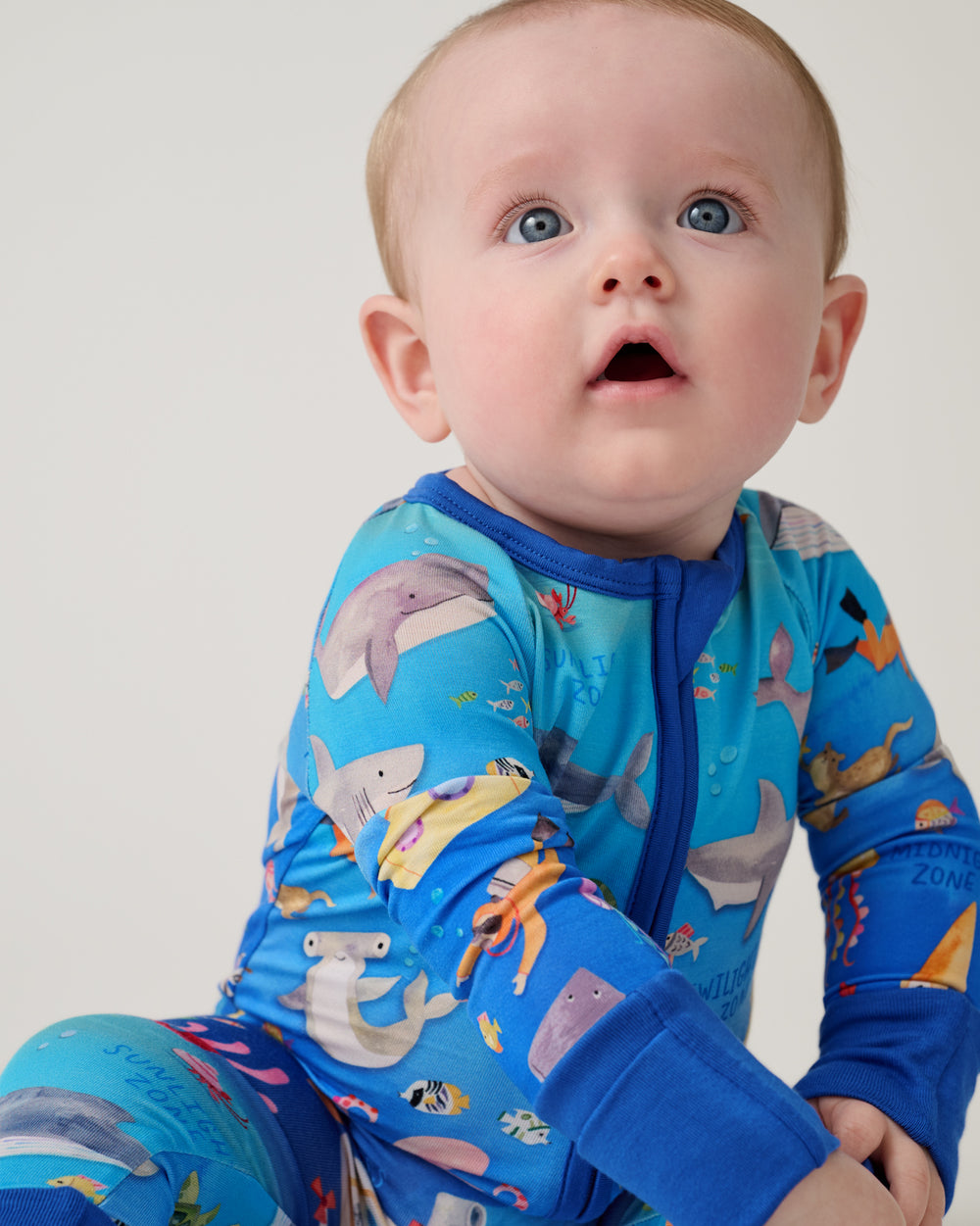 Close up of newborn wearing the Underwater Discovery Zippy
