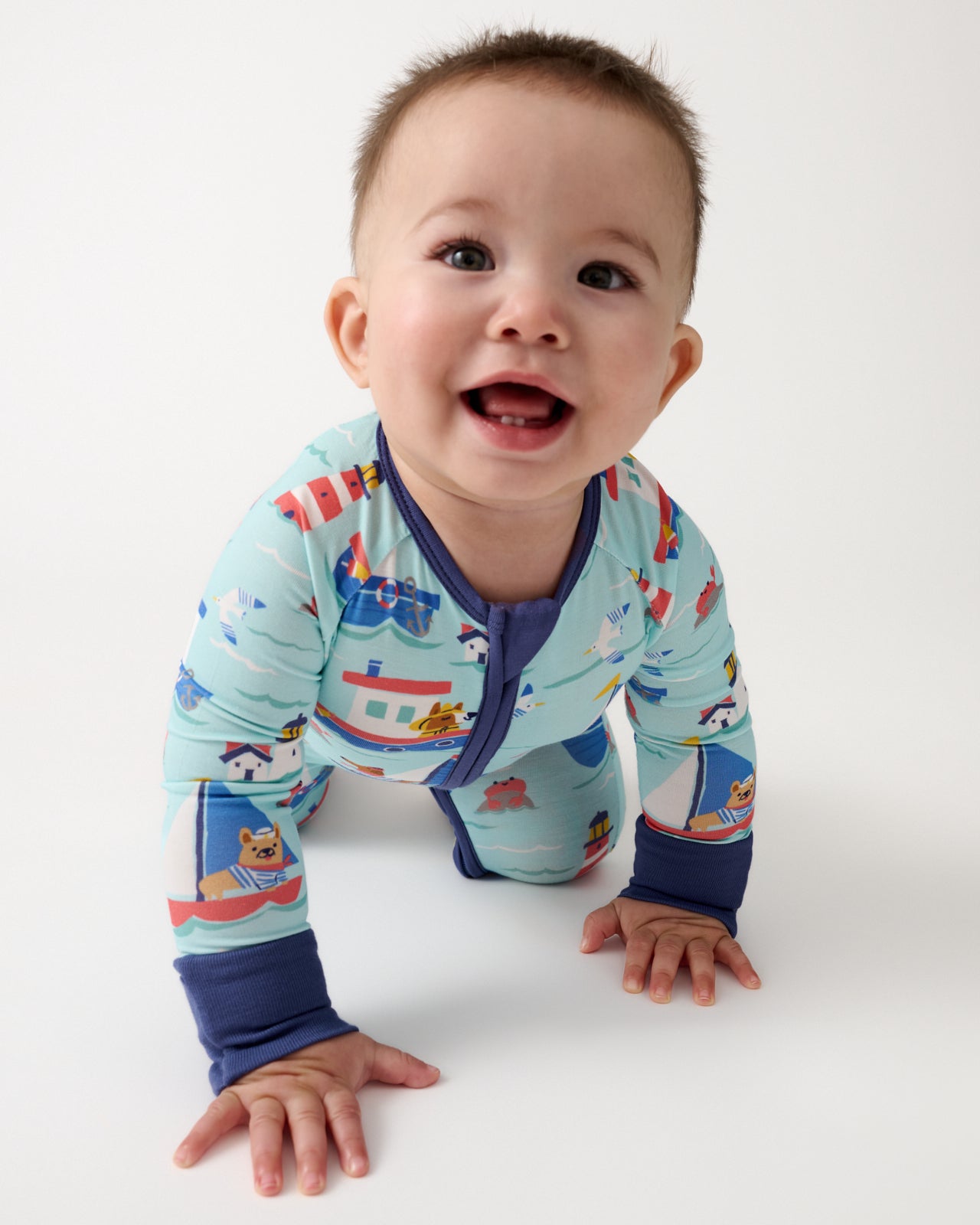 Crawling baby wearing the Nautical Paws Zippy