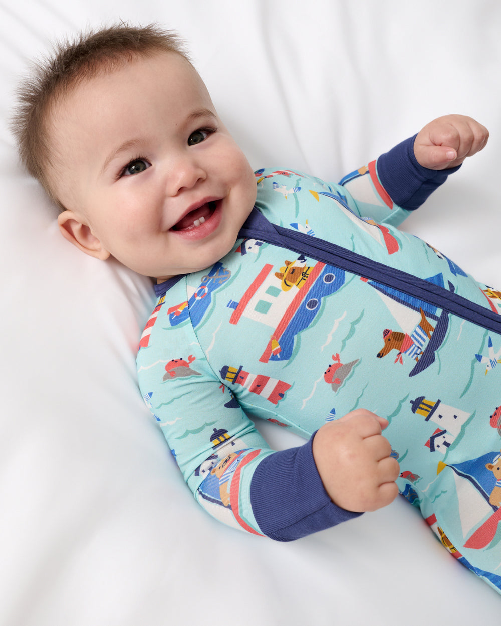 Close up of baby wearing the Nautical Paws Zippy