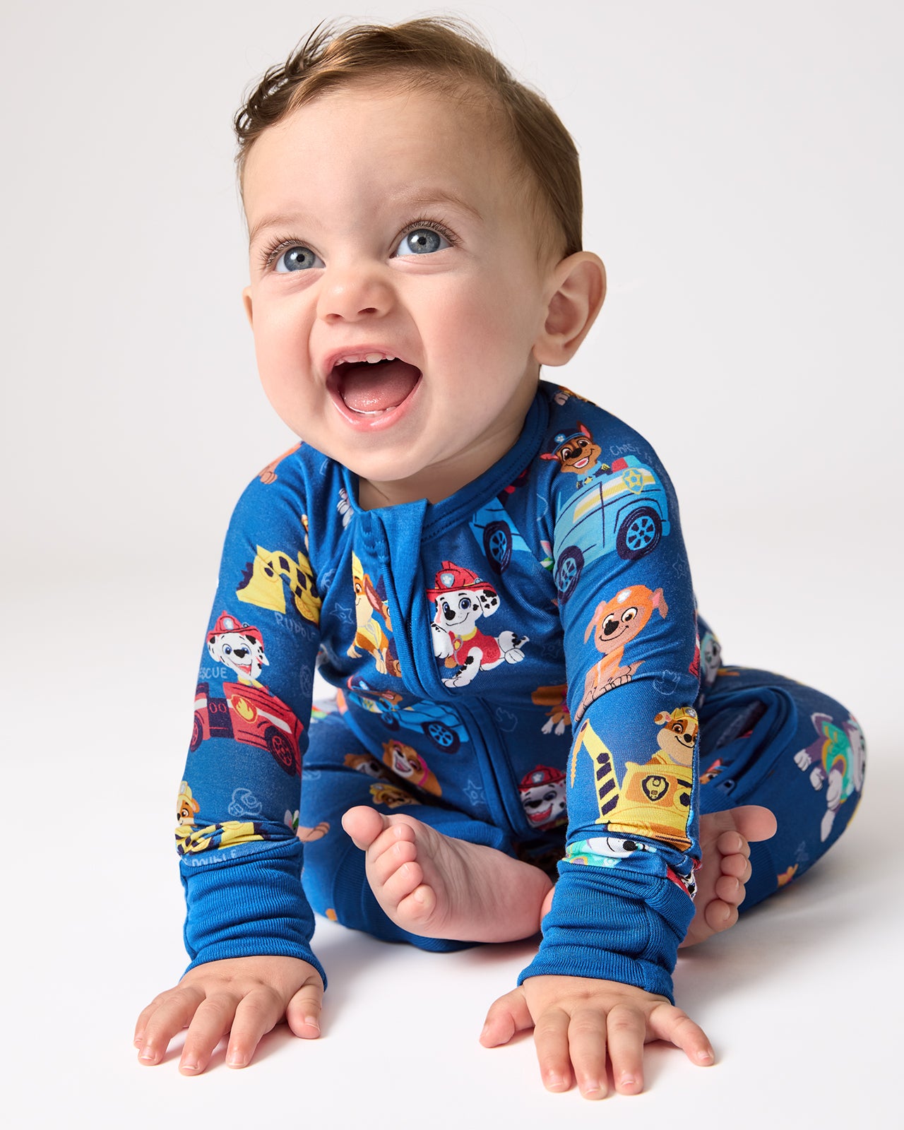 Sitting baby wearing the PAW Patrol Adventure Bay Heroes Zippy